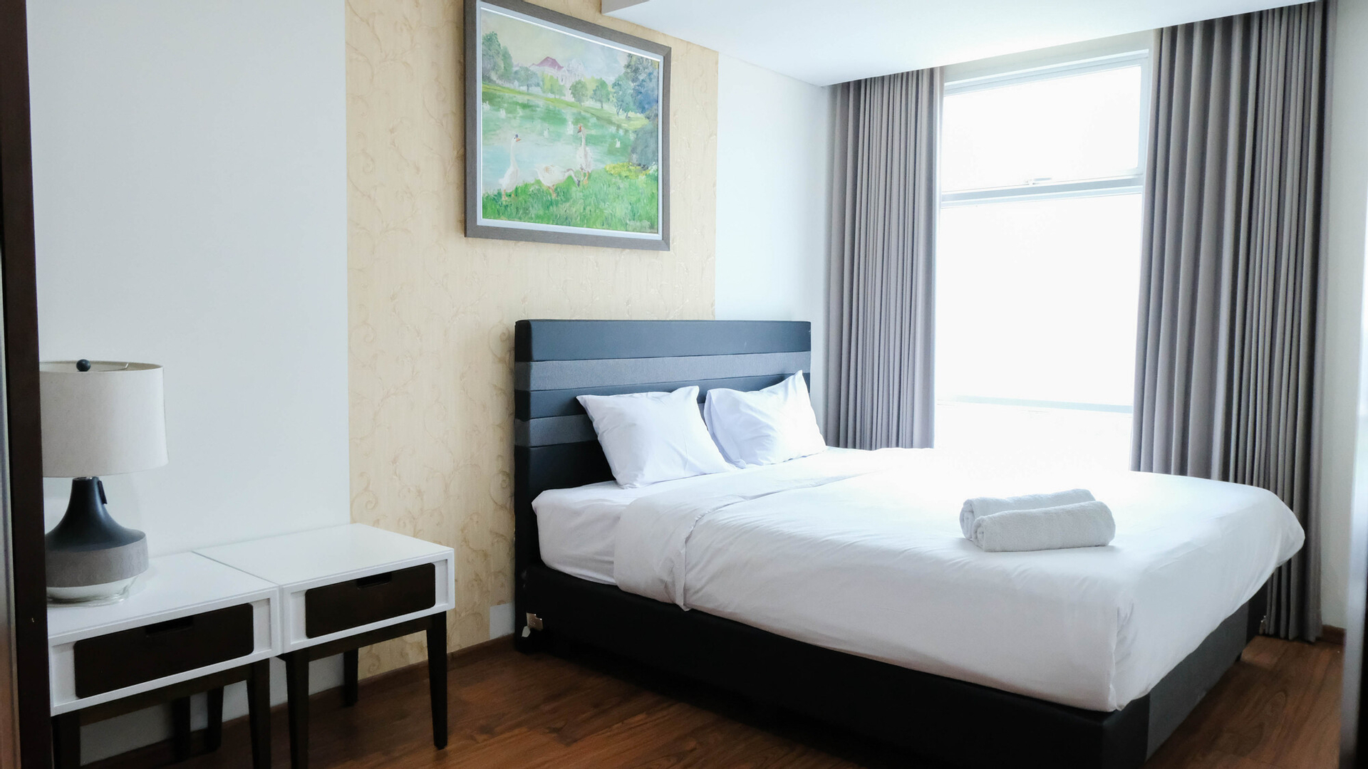 Bedroom 1, Spacious and Homey 1BR at Grand Sungkono Lagoon Apartment By Travelio, Surabaya