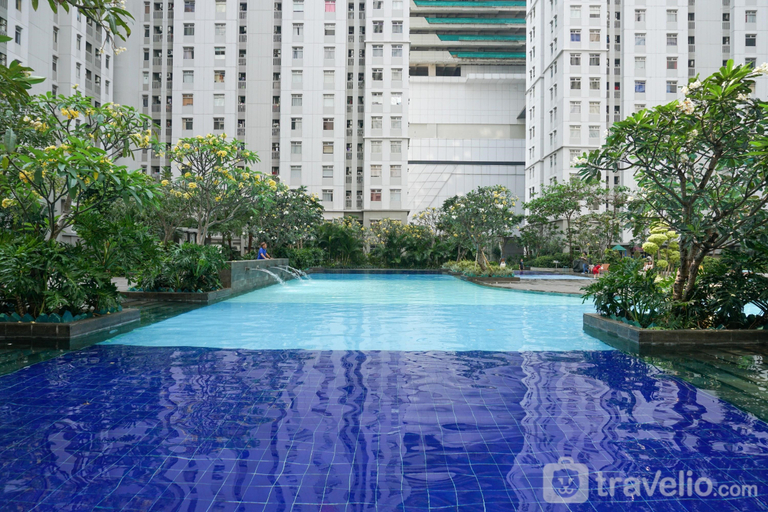 Swimming Pool 4, Luminous Modern 2BR at Apartment Green Bay Pluit By Travelio, North Jakarta