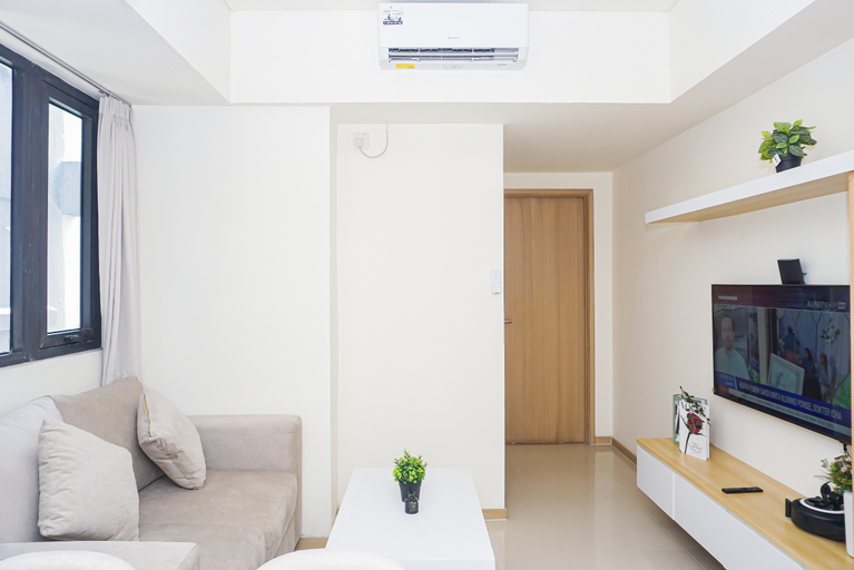 Living Room 4, Bright and Homey 2BR at Apartment Meikarta District 1 By Travelio, Cikarang
