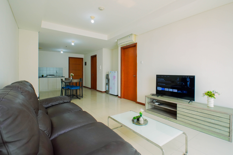 Living Room 3, Bright and Spacious 2BR at Apartment Green Bay Condominium By Travelio, North Jakarta