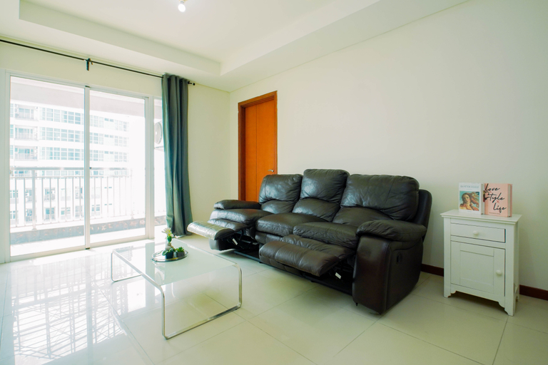 Living Room 4, Bright and Spacious 2BR at Apartment Green Bay Condominium By Travelio, North Jakarta