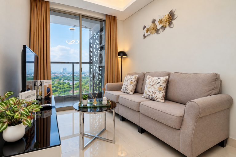 Living Room 3, Modern Comfy 1BR at Apartment Gold Coast By Travelio, North Jakarta