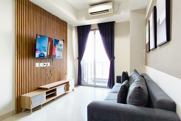Living Room 3, Capacious and Comfortable 2BR at Grand Sungkono Lagoon Apartment By Travelio, Surabaya