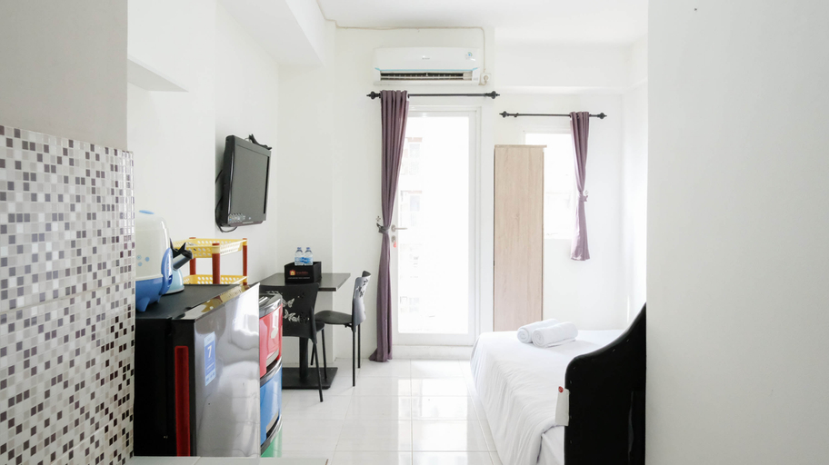Bedroom 2, Clean and Cozy Stay Studio at Puncak Dharmahusada Apartment By Travelio, Surabaya