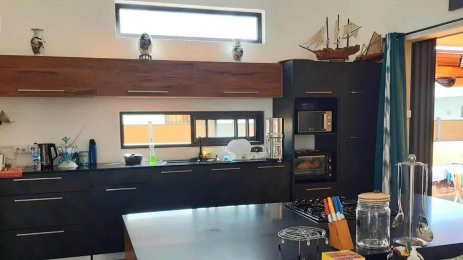 Private kitchen 4, Remarkable 3-bed House in Pointe aux Piments