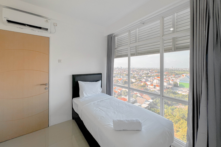 Bedroom 3, Spacious and Restfull 3BR at Bale Hinggil Apartment By Travelio, Surabaya