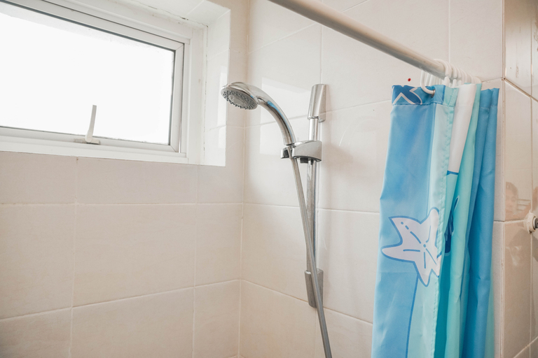 Bathroom 5, Spacious and Comfortable 2BR at Green Bay Condominium Apartment By Travelio, North Jakarta