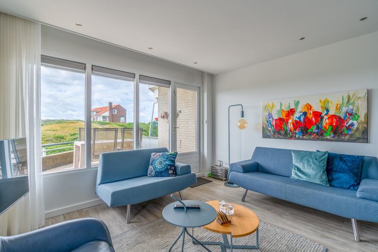 Living room 2, 4-person corner apartment with a beautiful view, Texel
