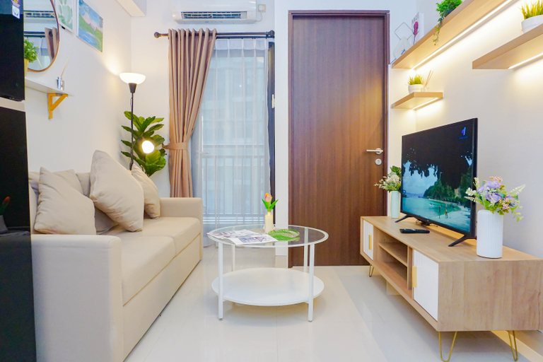 Living Room 4, Comfortable and Contemporary 2BR at Apartment Transpark Cibubur By Travelio, Depok