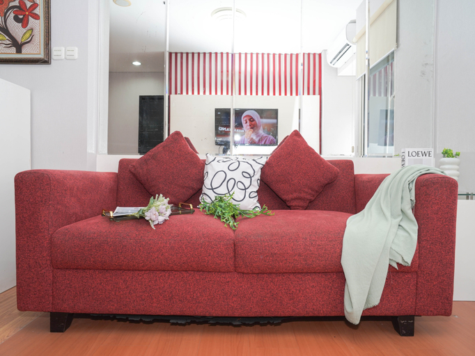 Living Room 4, Serene Red Vibe 2BR at Apartment Nifarro Park By Travelio, Jakarta Selatan