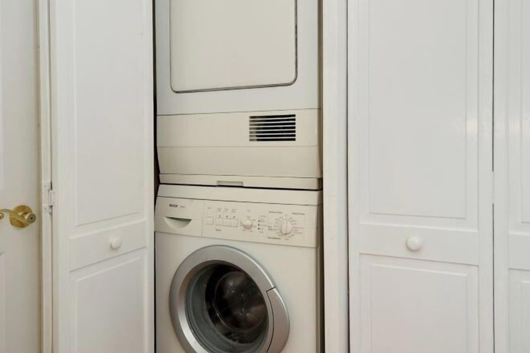 Laundry room, Charming 3-Bedroom Apartment in Midtown West, New York