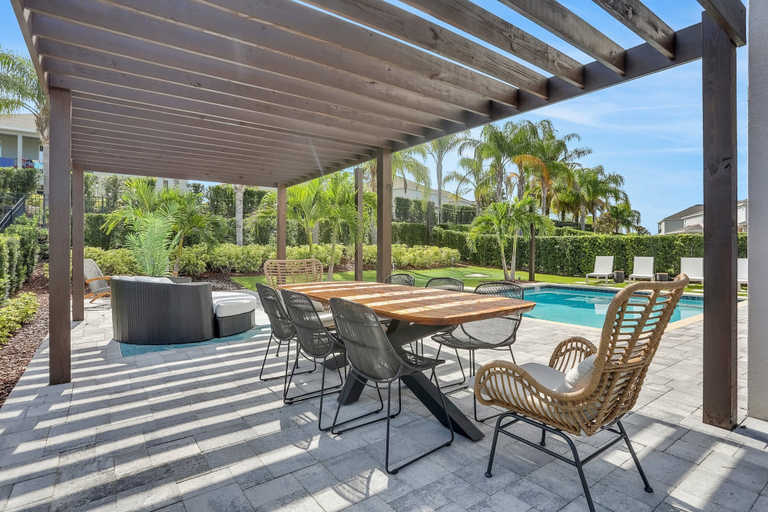 Outdoor dining, Dog-friendly Getaway With Private Pool + Spa, Putting Green, Patio, & Game Room, Osceola