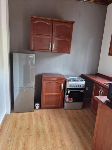 Private kitchen, Charming 2-bedroom Apartment in Yaoundé With Garden View, Mfoundi